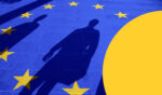A close-up of the EU flag with a human shadow over it