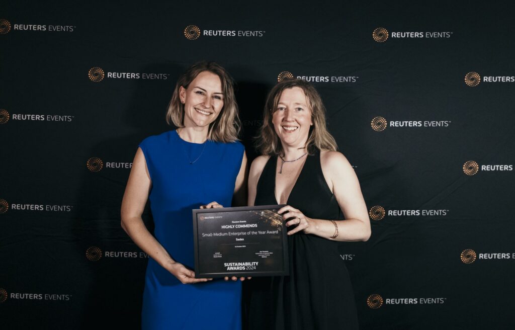 Two women hold an award certificate